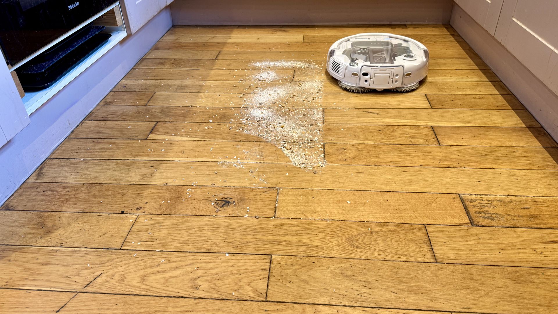 DJI Romo P robot vacuum mopping a wooden floor