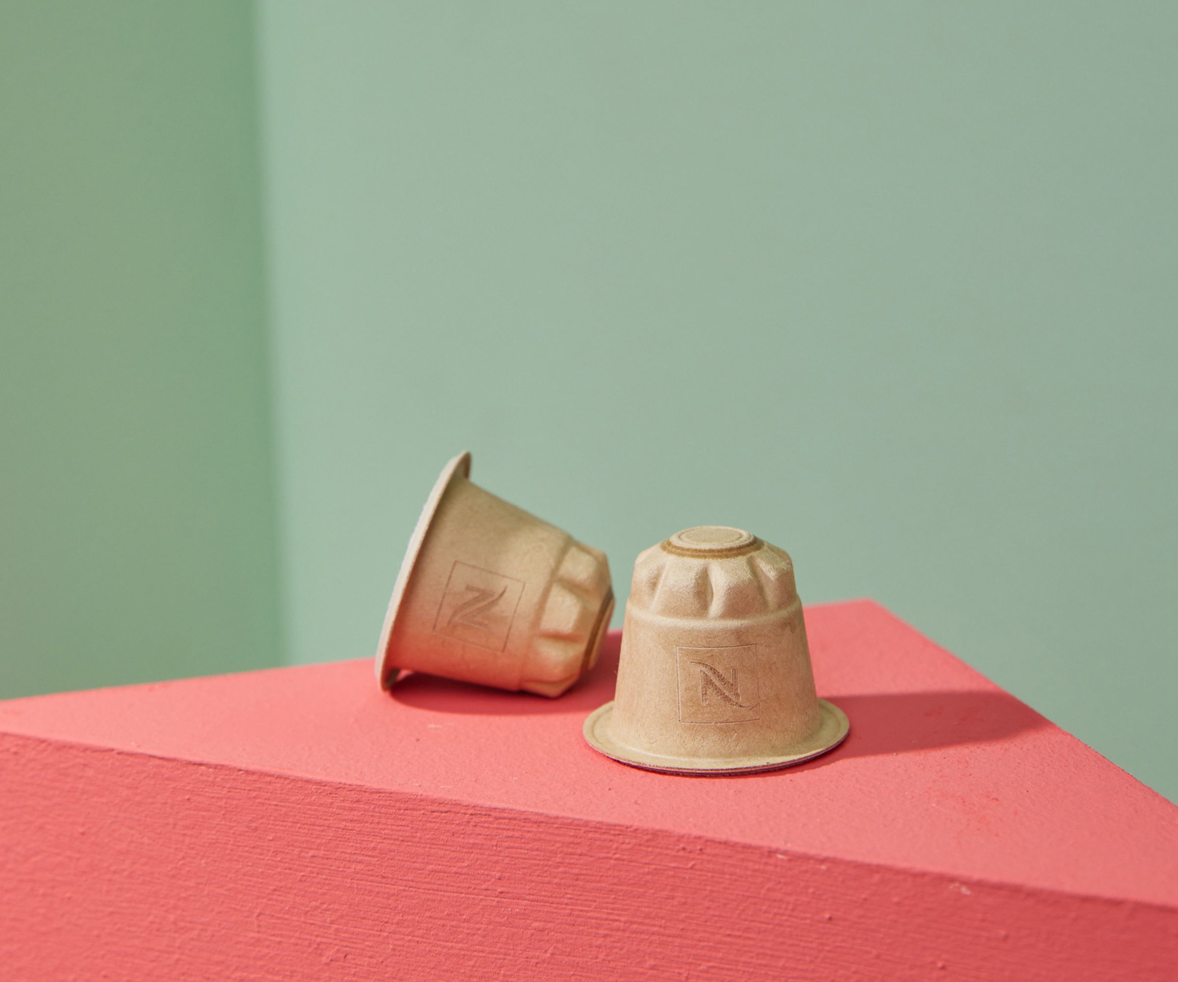 Nespresso paper coffee pod launch on a pink surface