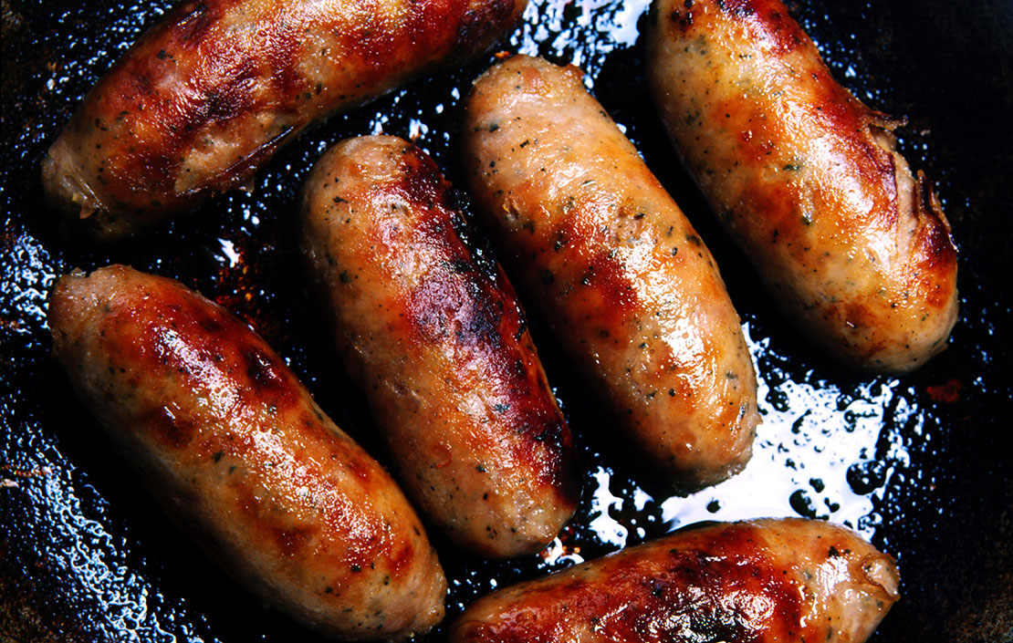 Brilliant British sausages cooking in a frying pan