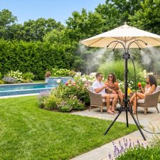 AI generated image of patio mister on a lush patio with swimming pool and people relaxing in the summer