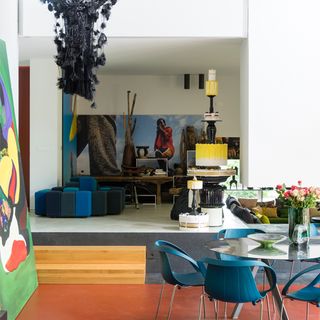 living space with dining table and paintings