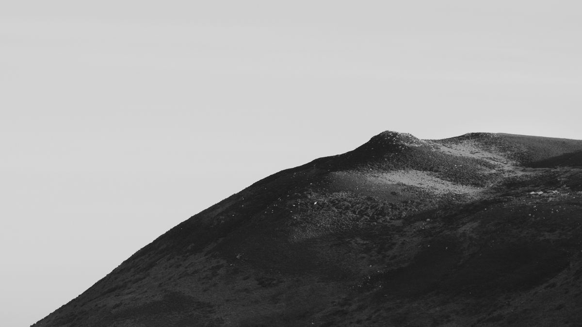 A black and white minimalist photograph of the Gower landscape in Rhossilli 