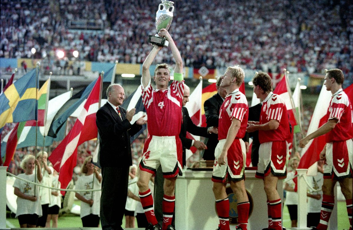 Denmark captain Lars Olsen holds the trophy aloft after Denmark's victory in the Euro 92 final against Germany