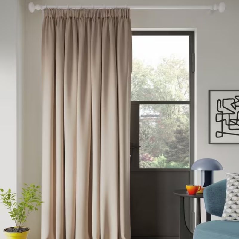 white room with black door and neutral curtain