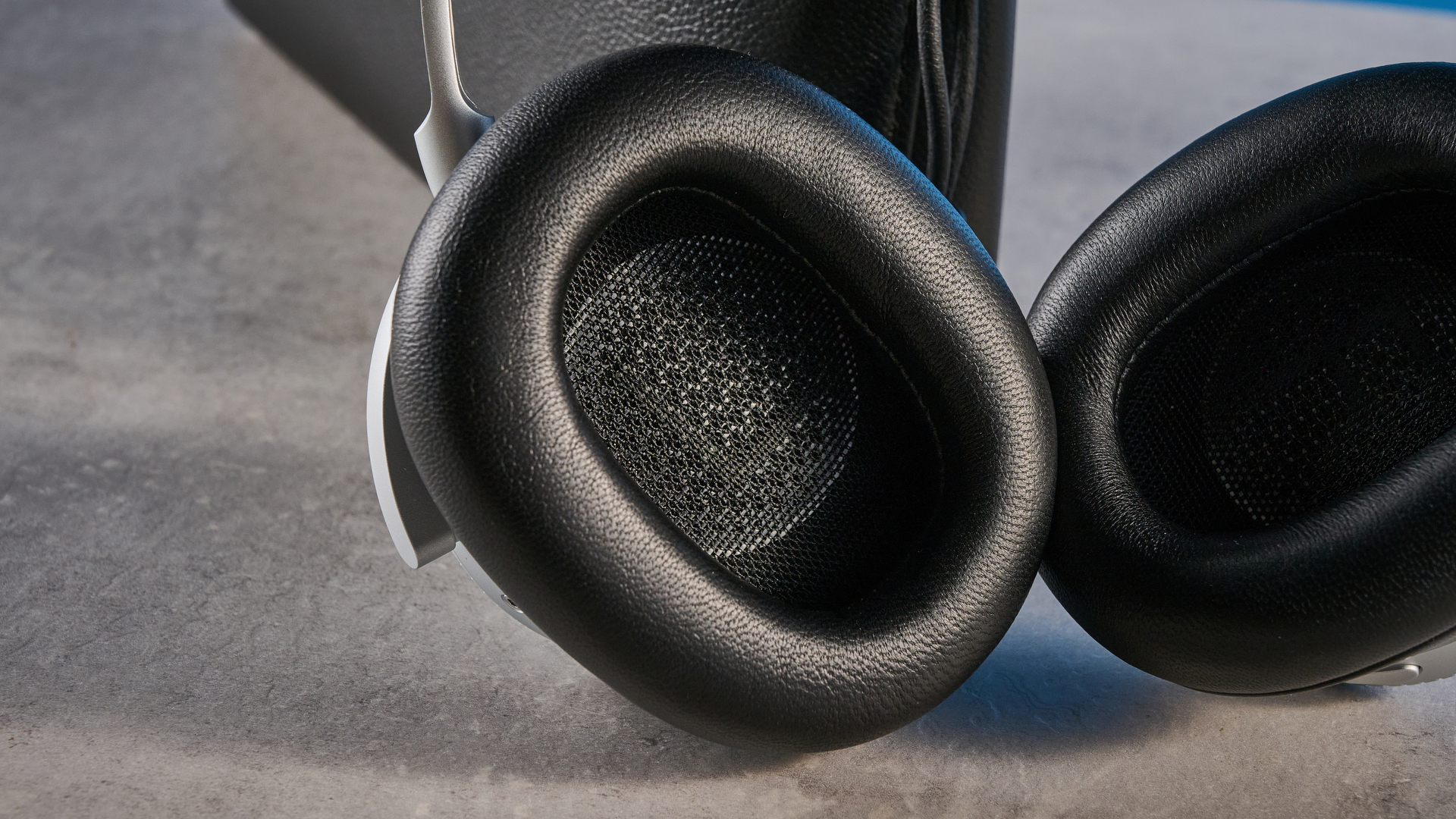 The Bang &amp;amp; Olufsen Beoplay H100 earcups on a stone surface