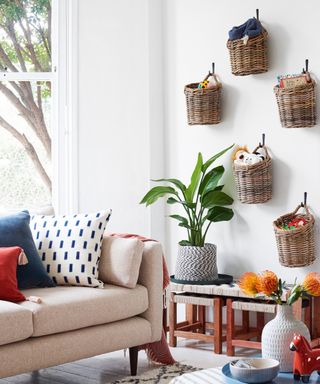 Woven baskets displayed on wall, filled with toys