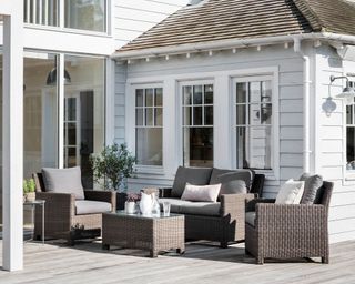 Outdoor living room with woven furniture and deck