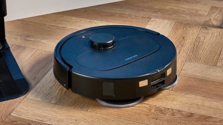 Roborock QV 35S photographed in front of a blue background