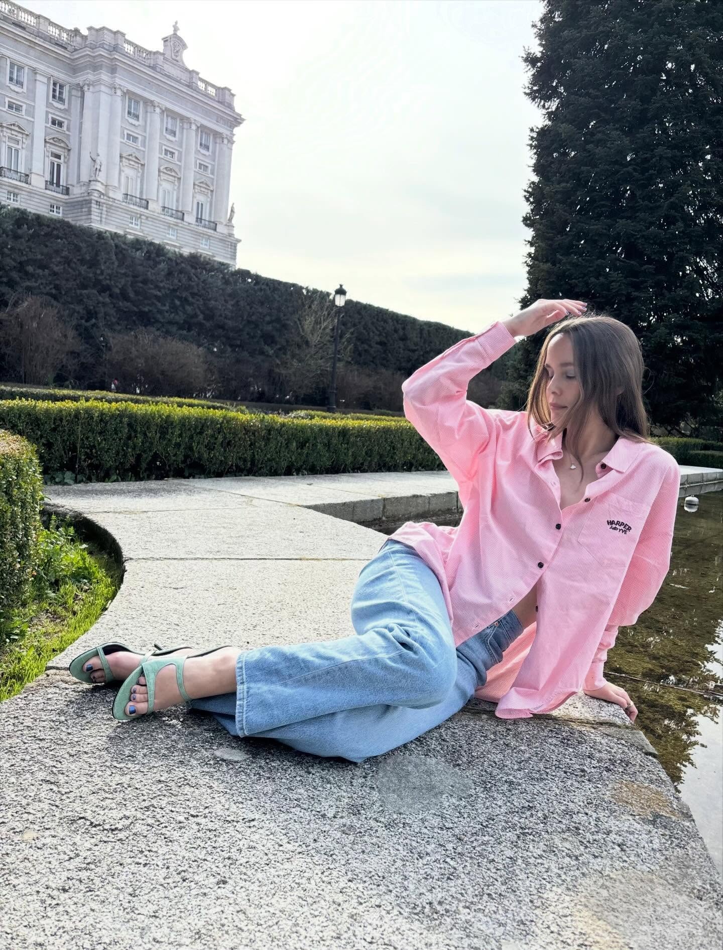 Woman in pale pink shirt and denim jeans