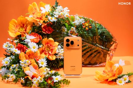 The Honor 600 Pro in orange in a lifestyle image