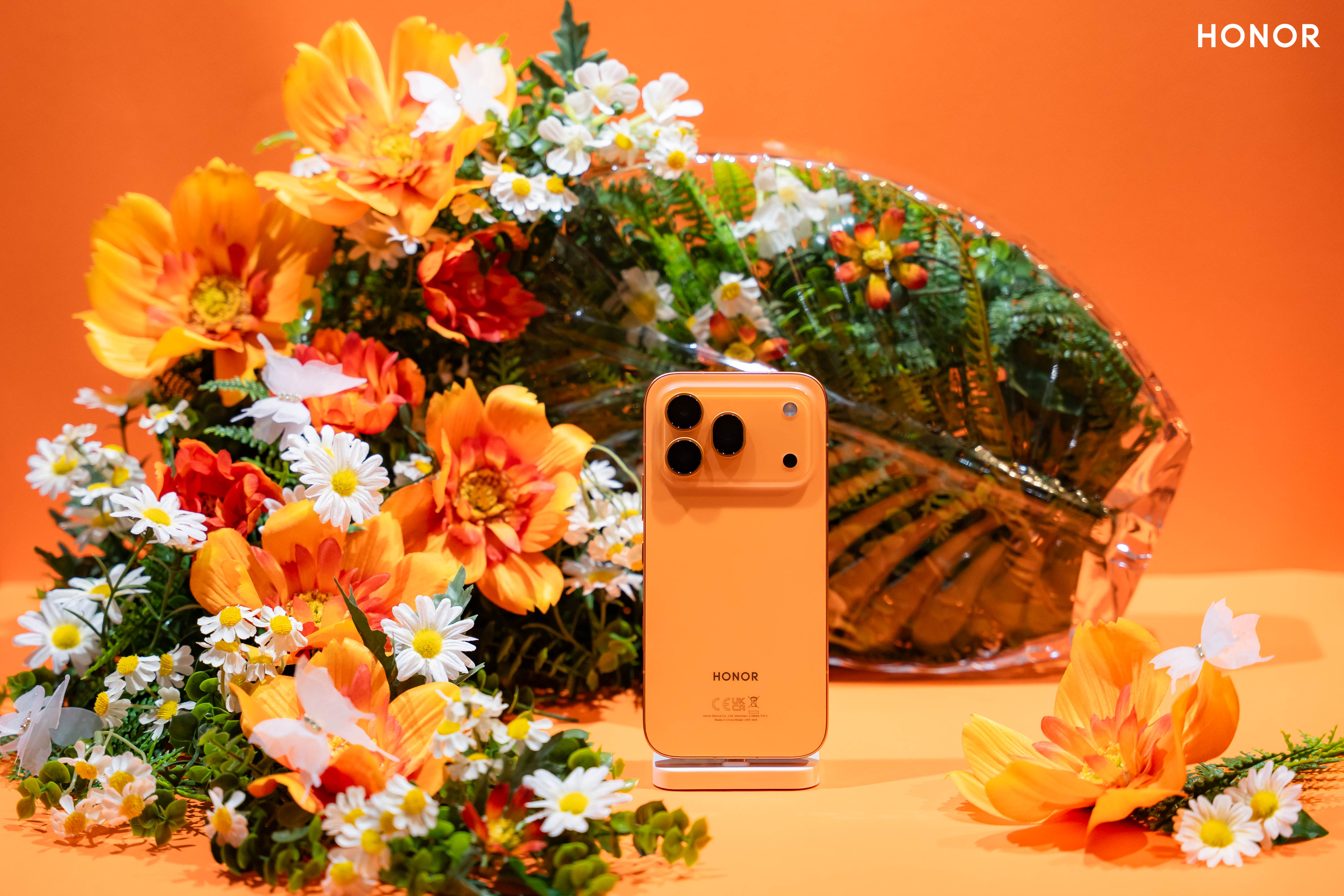 The Honor 600 Pro in orange in a lifestyle image