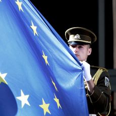 A Lithuanian soldier holds the flag of the European Union during a ceremony in front of the governmental palace in Vilnius on July 1, 2013. The small Baltic nation, the first to break free fr