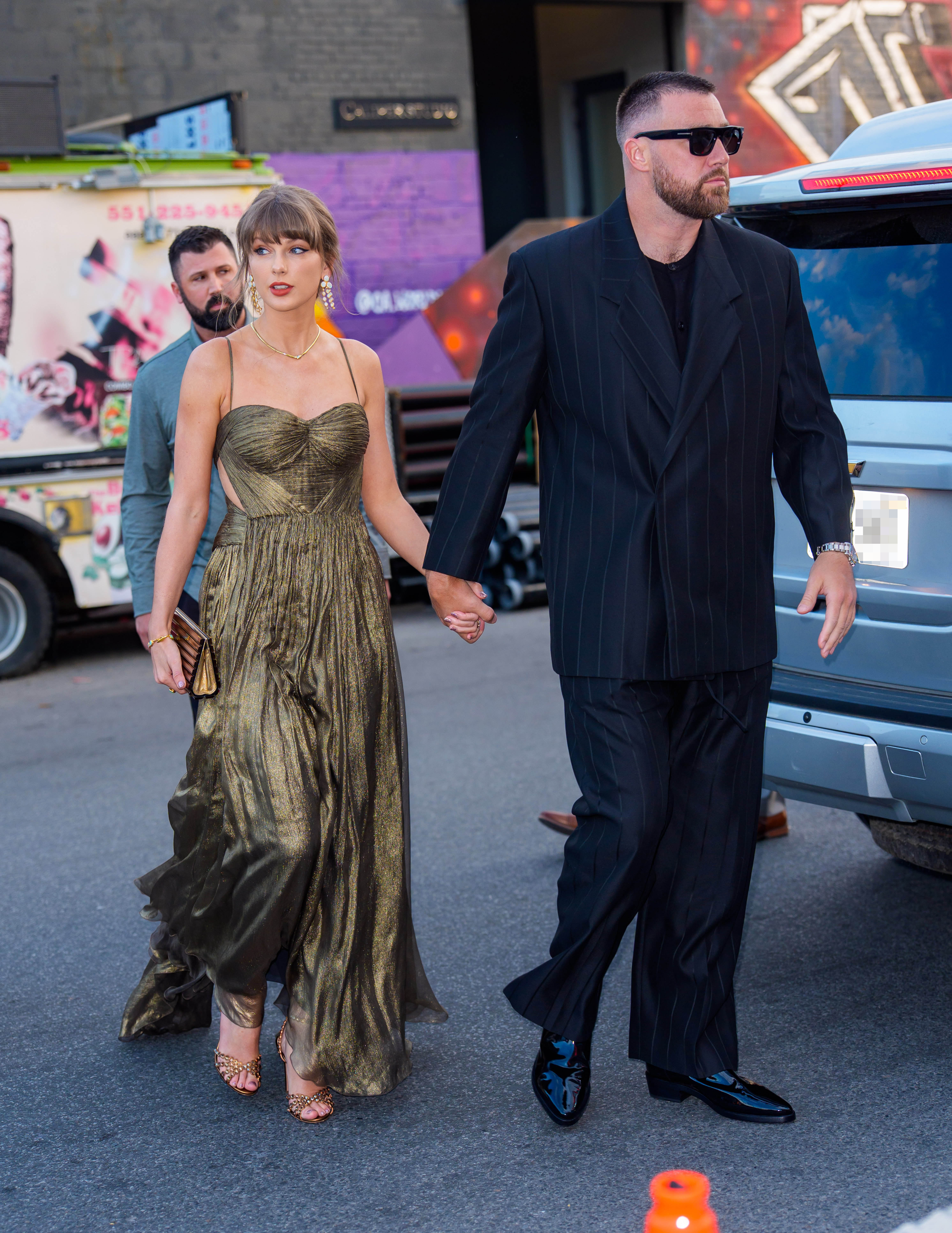 Taylor Swift's metallic gold wedding guest dress in May 2026