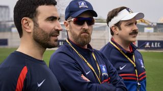 Roy Kent Coach Beard and Ted Lasso stood on a training field