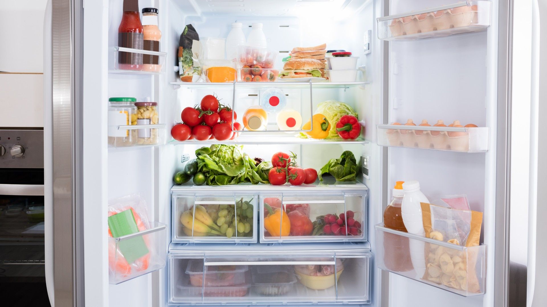 a tidy and organized white fridge full of food