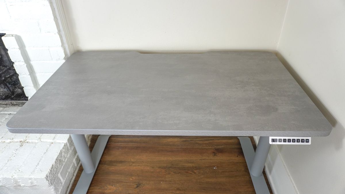 The fully assembled Hinomi S1 standing desk seen from above showing off its curved desktop and rounded legs