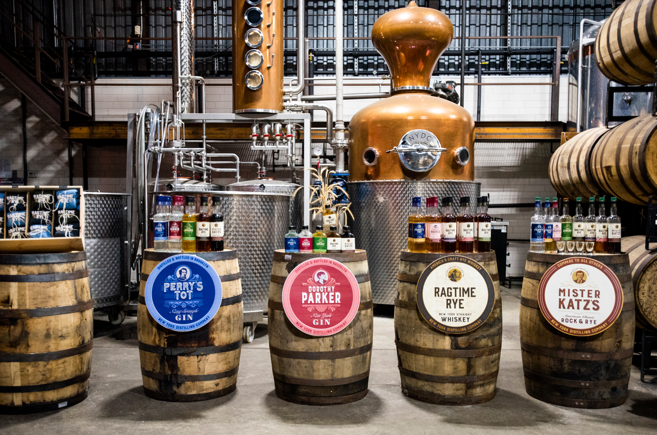 Interior of a distillery with a still, barrels and bottles