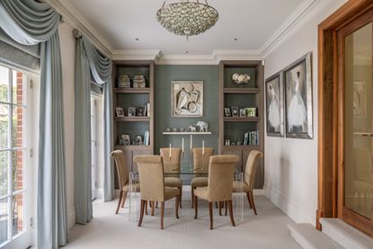 Blue wallpaper and curtains, glass dining table