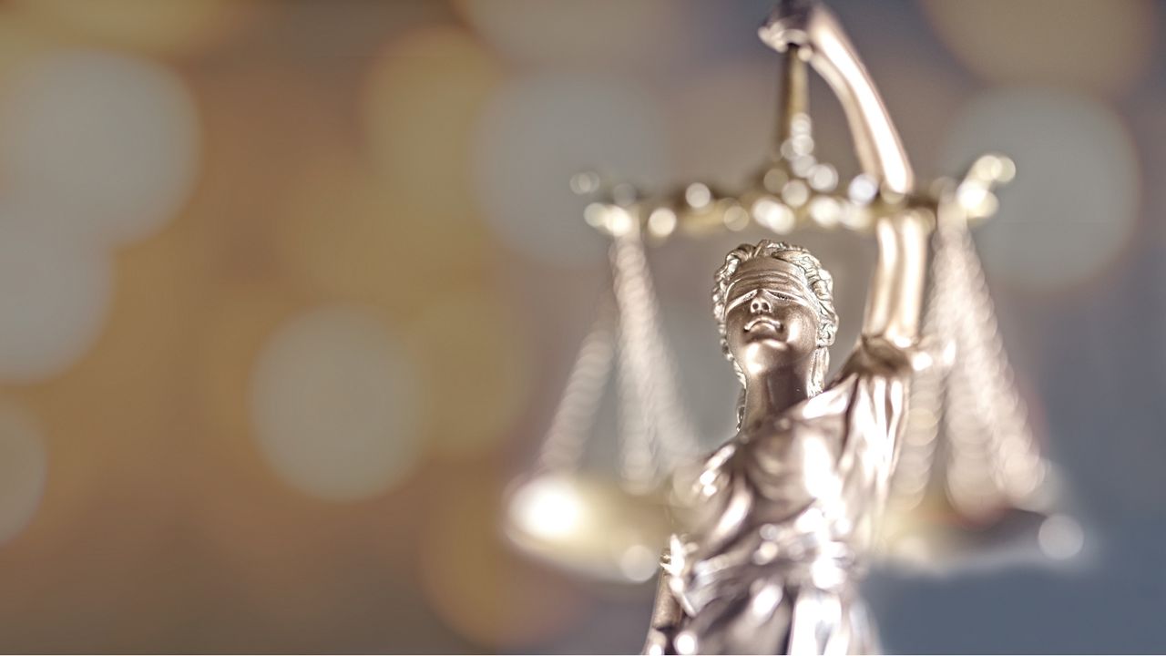 A sculpture of Lady Justice holding scales and wearing a blindfold.