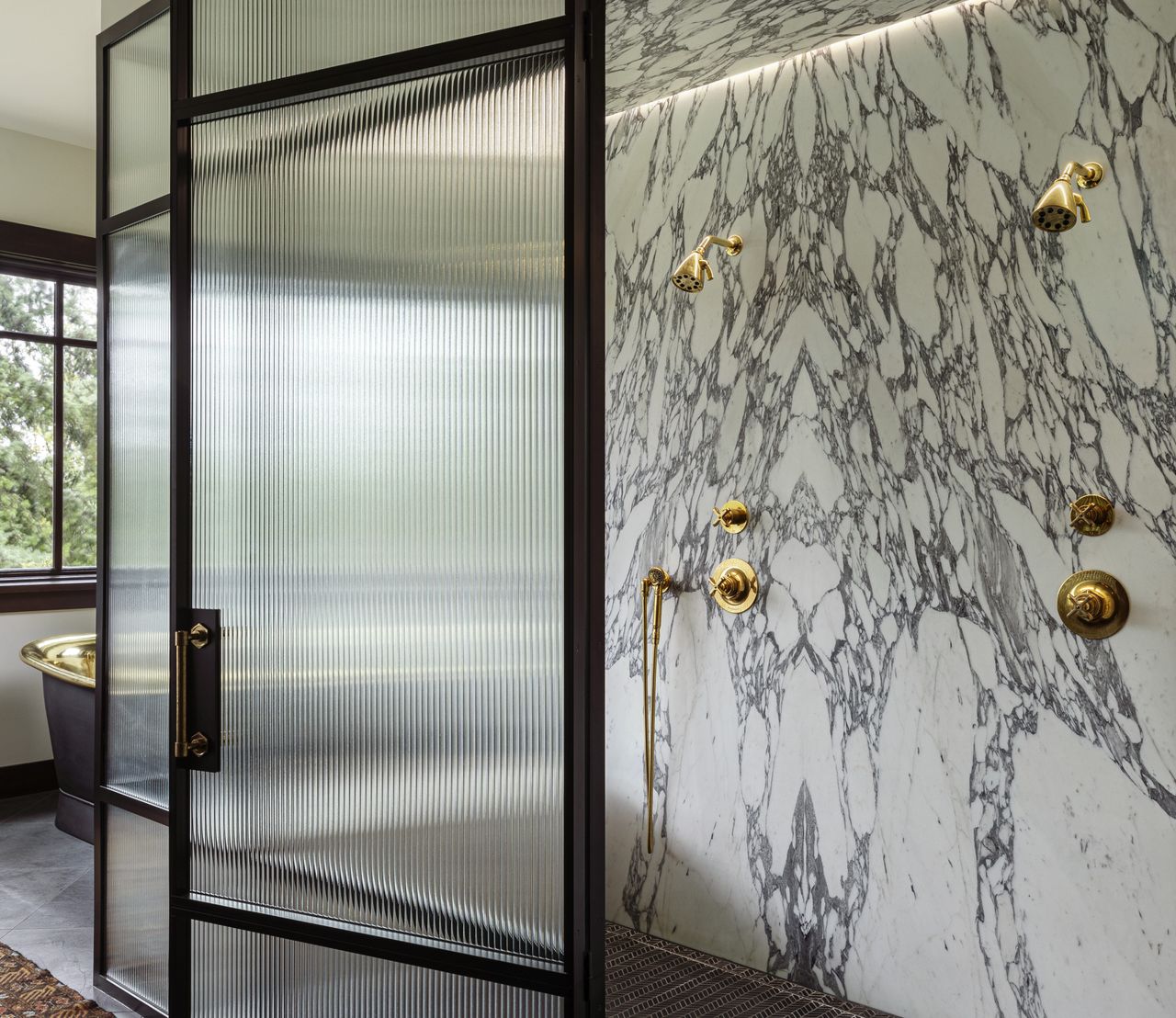 A shower enclosure with ribbed glass