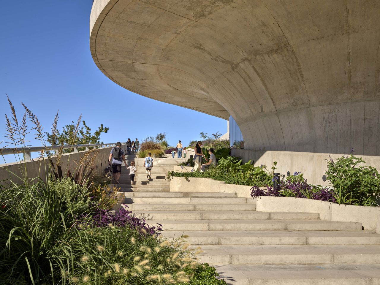 concrete brutalist building exterior stairs with planting