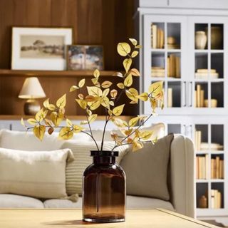 A piece of artificial greenery from Hearth & Hand with magnolia in a vase