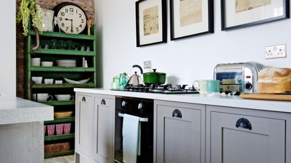 Kitchen with grey cabinetry and green open storage unit