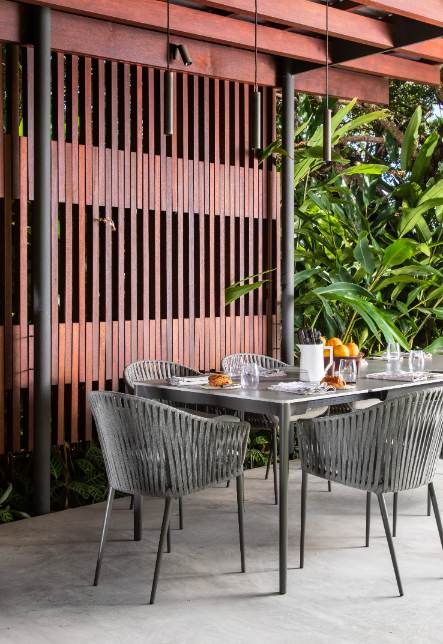 Outdoor dining area with wood paneled wall
