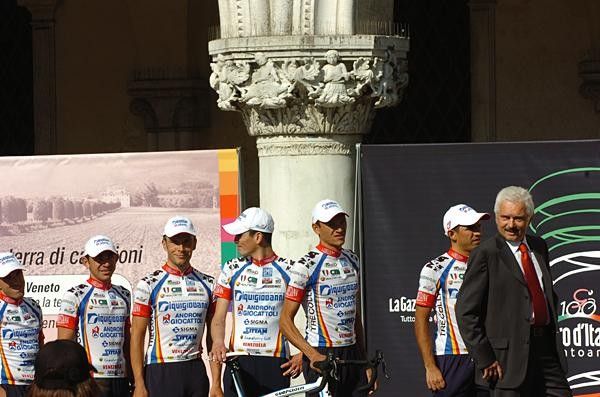 Gianni Savio leads is Diquigiovanni team onto the stage.