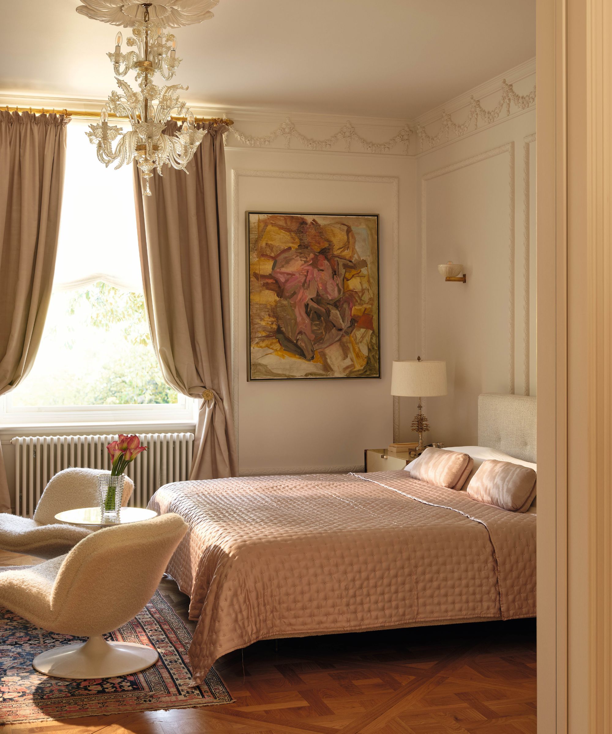 an ornate traditional victorian style bedroom with ornate molding with a mix of antique and mid century modern furnishings