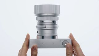 Hands holding the aluminum body of the Sigma BF camera