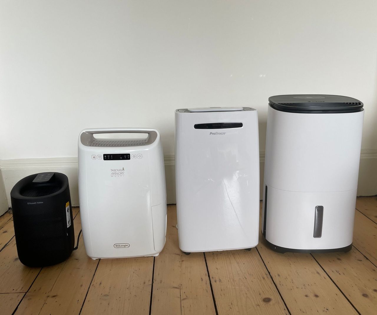 The De'Longhi, Pro Breeze, Meaco, and Russell Hobbs dehumidifiers lined up on the floor