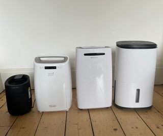 The De'Longhi, Pro Breeze, Meaco, and Russell Hobbs dehumidifiers lined up on the floor