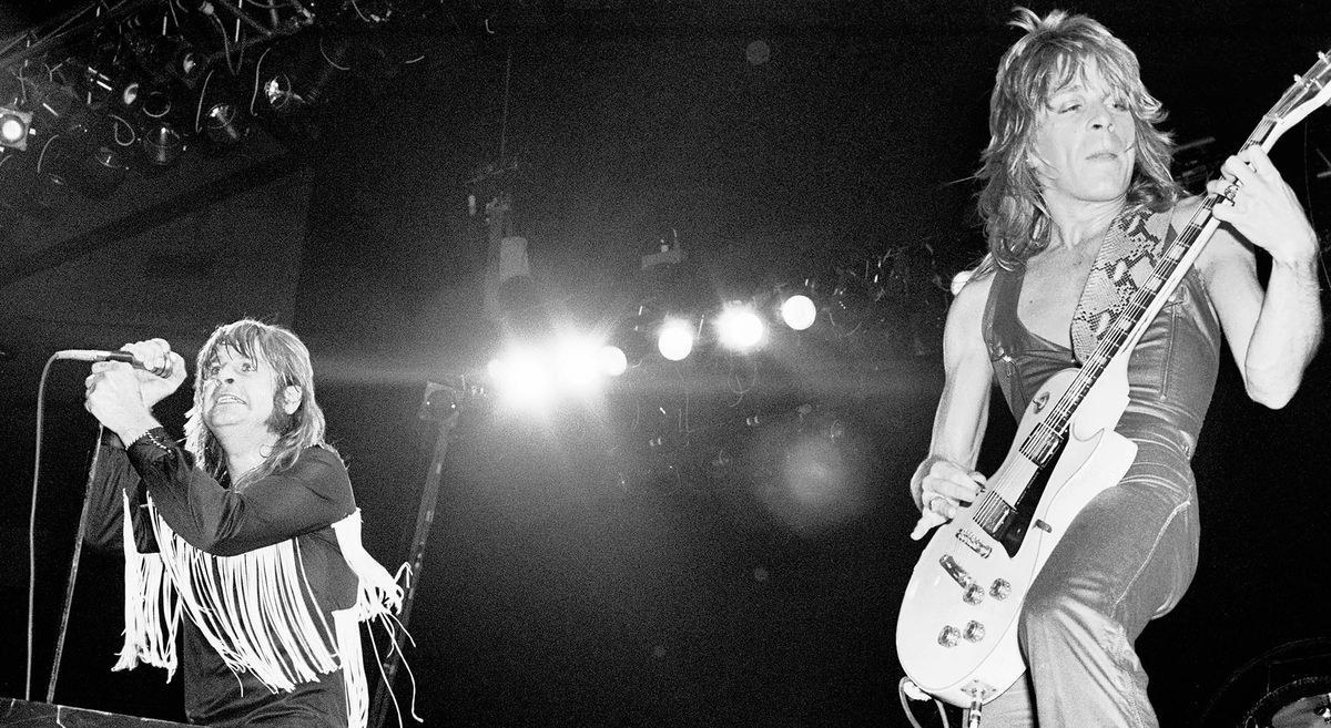 Randy Rhoads riffs on his Gibson Les Paul Custom as Ozzy Osbourne mans the mic on the far-left of the image, in this live shot from the Blizzard of Ozz Tour 1981.