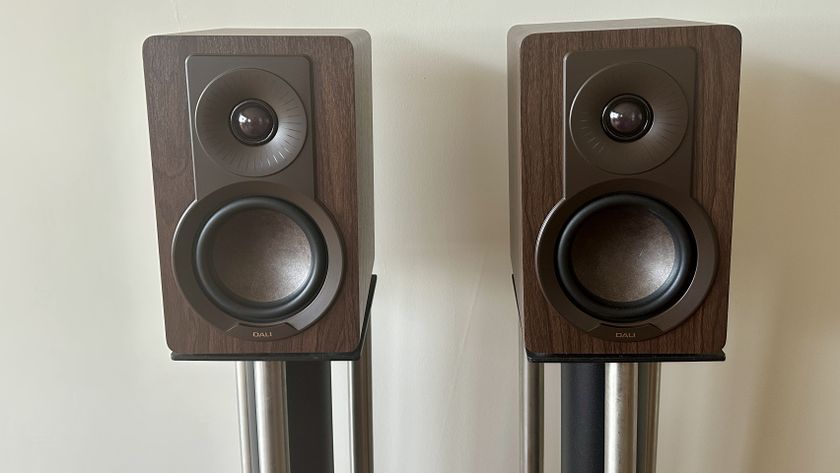 A pair of Dali Kupid bookshelf speakers, each placed on separate speaker stands.