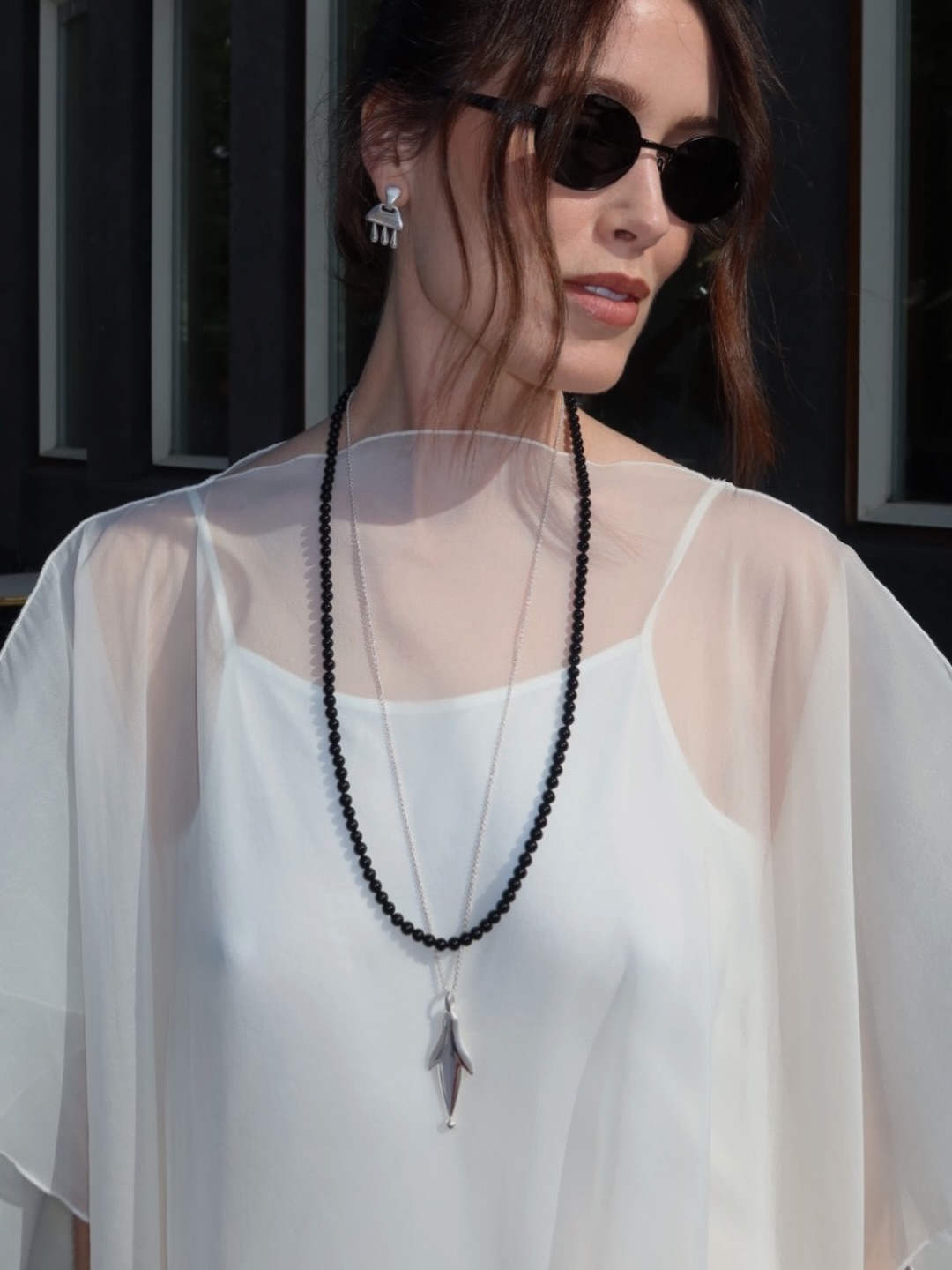 Annabel wearing black bead necklace and silver pendant necklace