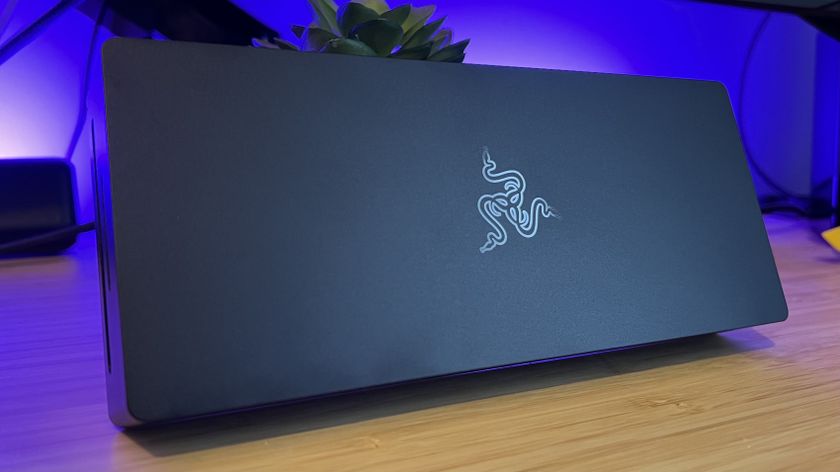 Razer Thunderbolt 5 Dock Chroma on a wooden table with purple backlighting
