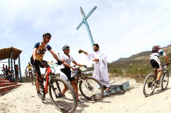 Racers are blessed by a priest