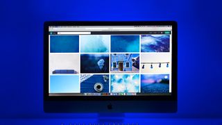 Mac on a desk backlit by blue lighting