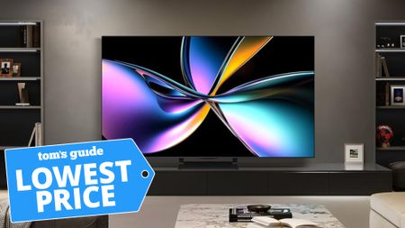 The Hisense U75QG Mini-LED TV displaying a colorful, abstract image on a credenza in a modern living room