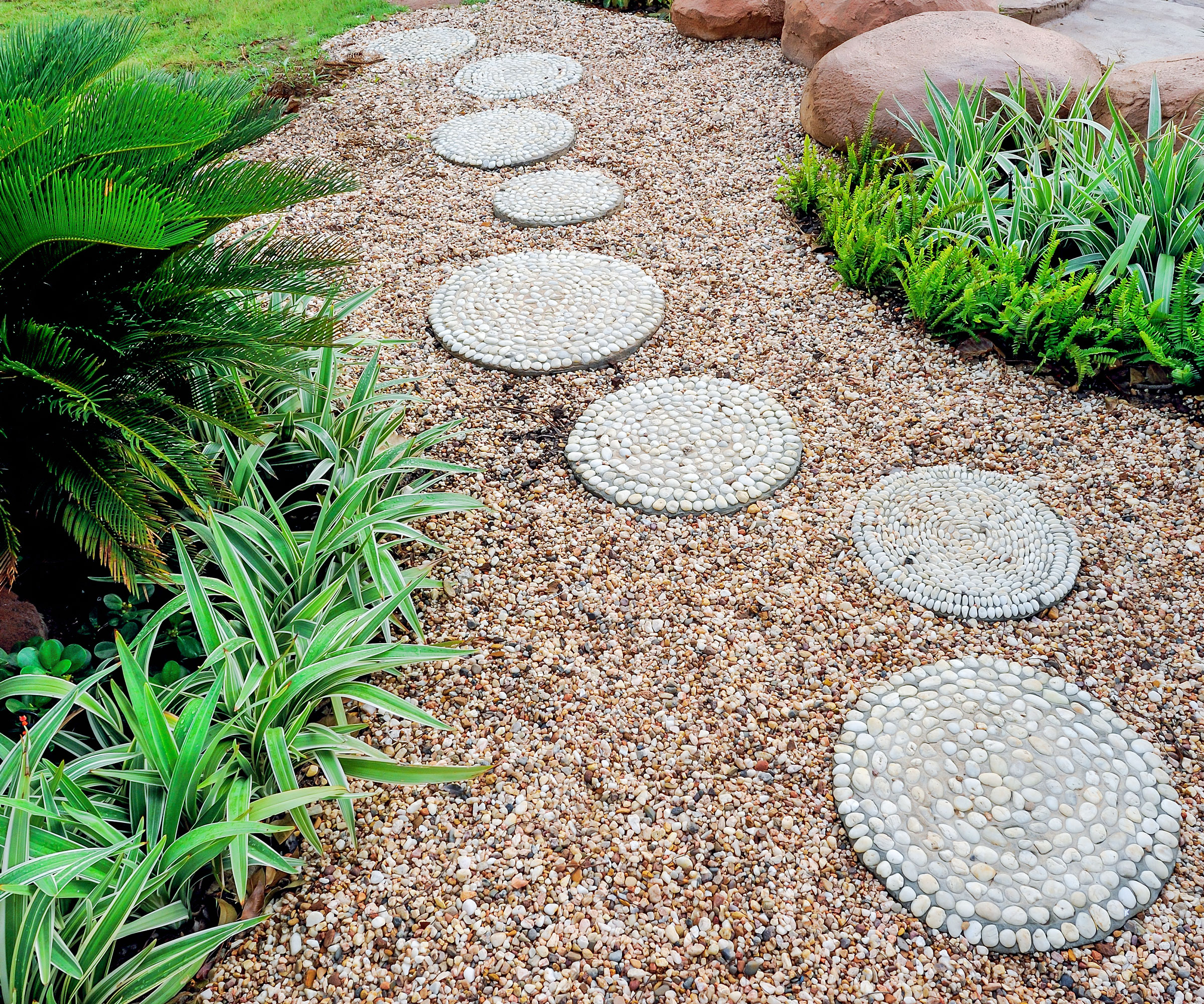 circular stepping stones and gravel in backyard
