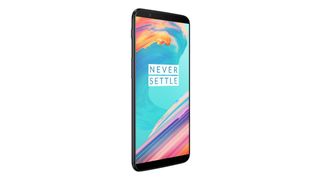 Black OnePlus 5T smartphone with the large screen displaying the Never Settle Motto