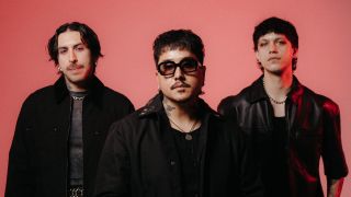 Dayseeker dressed in black against a pink background