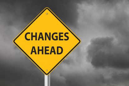 yellow diamond sign that says "changes ahead" against stormy backdrop