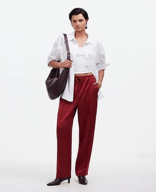 Madewell model wearing white button-down, white t-shirt, and red silky trousers