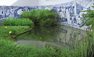 Pond next to blue mosaic wall