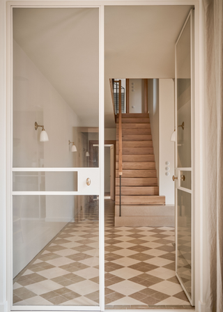 neutral hallway with checkerboard tile design flooring