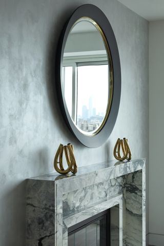 A mirror above a mantle piece in the living room