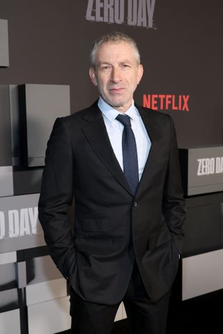 mark ivanir wearing a black suit and tie on the carpet for the premiere of zero day