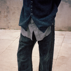 woman wearing navy sweater and black jeans